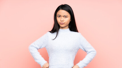 Fototapeta premium Teenager Chinese woman isolated on pink background angry
