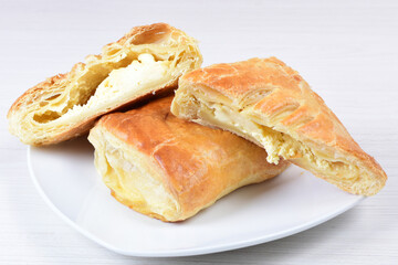 Cheese puff pastry displayed on white wooden background
