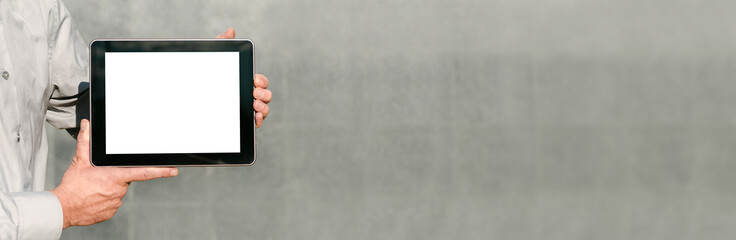Banner Close up, Mock up tablet, presentation of business plan, man hands. against the background of a concrete wall.