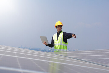 Asian engineer for solar panel inspection roof construction. Engineer worker installing solar panels outdoors