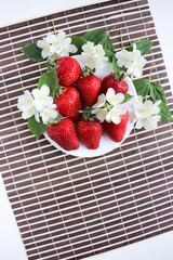fresh ripe strawberries on a white dish