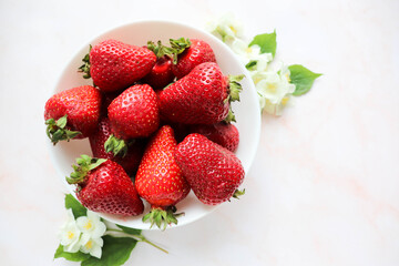 fresh ripe strawberries on a white dish