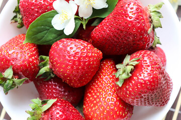 fresh ripe strawberries on a white dish