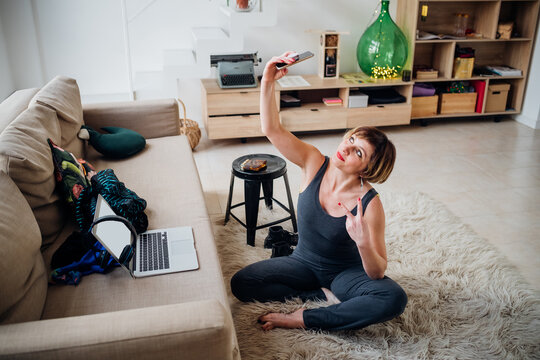 Adult Woman Indoors At Home Post Online Workout Taking Selfie