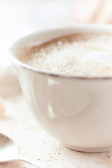  Coffee with milk on bright stone background. Close up.