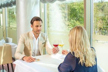 Attractive couple toasting in a hotel restaurant