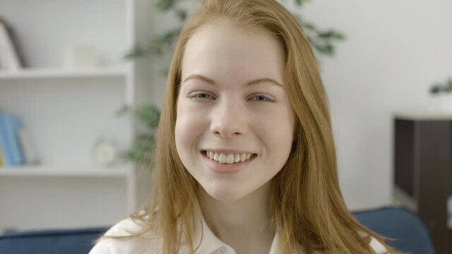 Happy teen girl smiling on camera, expressing joy and good mood, close-up