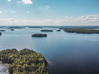Beautiful lakeview of lake Saimaa in Puumala, Finland. Sail boat in far distance.