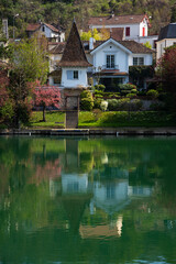 Fototapeta na wymiar Scenic springtime view of houses at Marne river (Boucles de Marne) in Val-de-Marne department of Ile-de-France. Beautiful reflection.