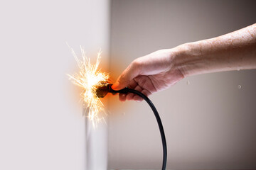 Wet hand connecting electrical plug cause electric shock, Idea for causes of home fire, Electric short circuit, Electrical hazard can ignite household items, Residential building electrical fires.