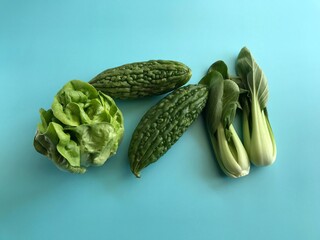 green vegetables on colored background