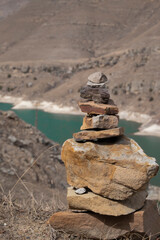 Fototapeta na wymiar Balanced rocks in the mountains on the background of a blue lake