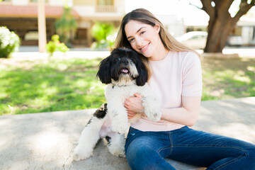 Beautiful woman and her puppy feeling happy