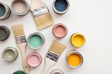 Overhead view of a DIY paint brush with colorful sample paint pots