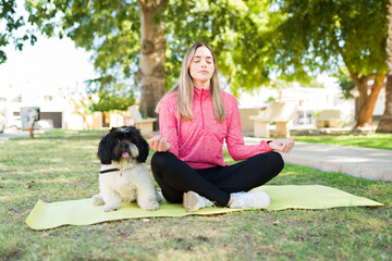 Fototapeta premium Active woman working out outdoors with her puppy