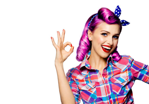 Pin up girl. Portrait photo of excited happy smiling purple hair woman showing ok hand sign gesture. Retro and vintage concept. Isolated over white background. Caucasian model posing at studio.