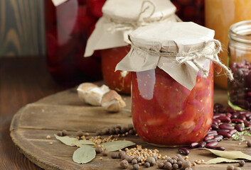 Canned kidney bean in tomato paste in glass plastic free jar on rustic table, closeup, canned produce, vegan meal prep, food storage solution, saving leftovers concept