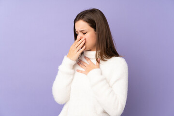 Teenager girl isolated on purple background is suffering with cough and feeling bad
