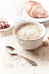 Coffee with milk on bright stone background. Close up.