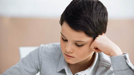 cute Preteen boy looking away at home.