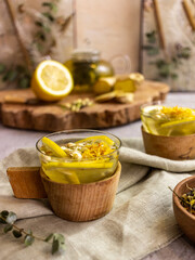 green tea with lemon and ginger on a wooden background