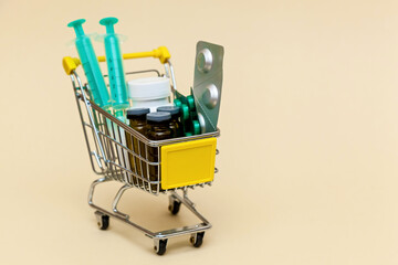 Metal shopping cart on a beige background.