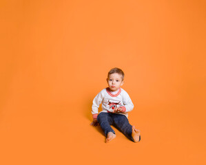 child in jeans and a white sweater