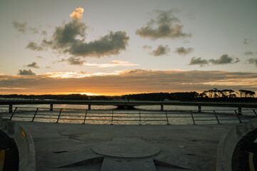 Fototapeta na wymiar circular bridge in uruguay at sunset - Laguna Garzón