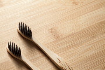 Kit of toothbrushes on the rustic wooden table in the bathroom. Warm and welcoming atmosphere. With neutral and isolated background. Spa concept. Personal hygiene concept.
