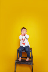 child in jeans and a white sweater