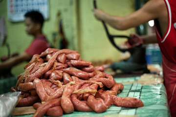 Unrecognizable man making sausages for selling on street food market