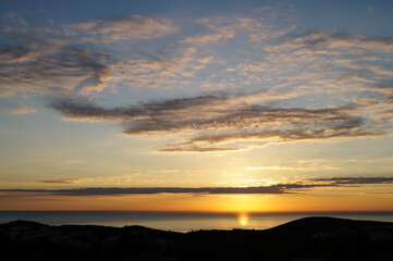 romantic golden sunrise over the sea and subtle cloud structure