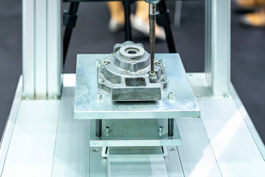 close up hex wrench tool of automatic tighten bolt machine during assembly workpiece or automobile part with support platform