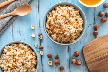 Oats porridge over rustic background. Breakfast ideas. Top view.