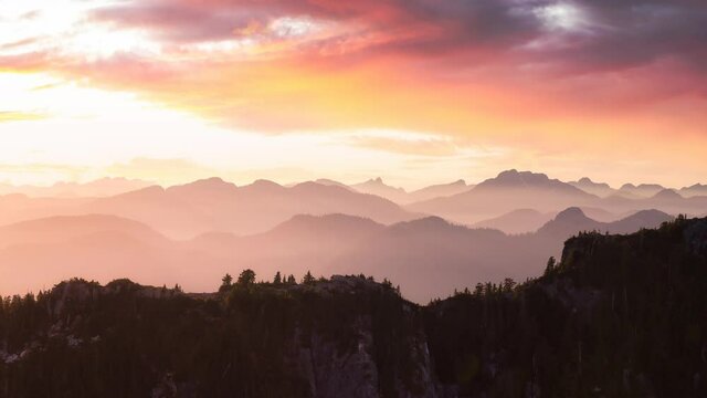 Cinemagraph Continuous Loop Animation of Aerial view from above of Rocky Mountains. Canadian Nature Background. Located near Squamish and Vancouver, British Columbia, Canada. Sunset Sky