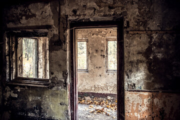 Windows in an old abandoned room with old cracked plaster.