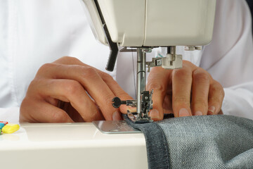 process of shortening jeans pants on a sewing machine