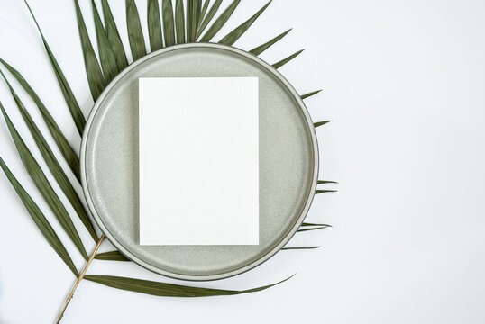 Blank Greeting Or Invitation Card Mockup With Palm Leaf And Ceramic Plate