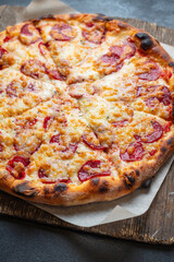 pizza pepperoni sausage tomato sauce and cheese trend fast food meal copy space food background rustic. top view