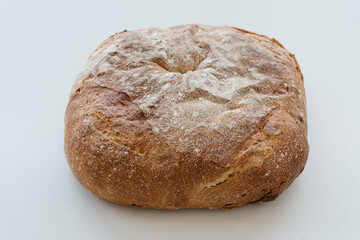 Freshly baked loaf of bread on white table. Helathy lifestyle and nutrition. Carbohydrates and gluten, diet.