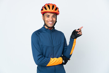 Young cyclist Brazilian man isolated on white background pointing finger to the side - obrazy, fototapety, plakaty