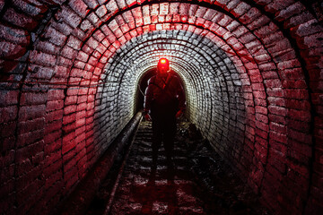 Man in protective suit inside abandoned uranium mine