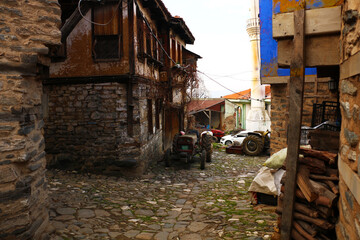 Fototapeta na wymiar selective focus. old tractors and old village houses in Bursa in Turkey's history has been abandoned.