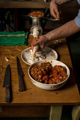 hands of man making salame