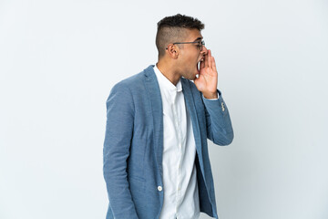 Fototapeta premium Young business Brazilian man isolated on white background shouting with mouth wide open to the side