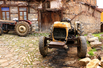 selective focus. old tractors and old village houses in Bursa in Turkey's history has been abandoned.