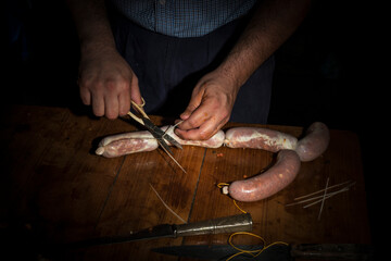 hands of man making salame