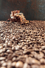 Roasted coffee beans with anise and cinnamon sticks.