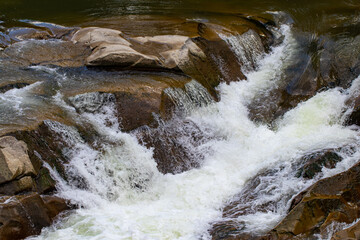 bubbling water and stones. Falling waterfall. Background texture