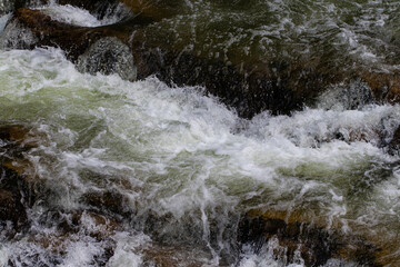 bubbling water and stones. Falling waterfall. Background texture